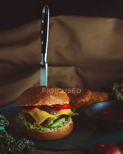 focused_171415856-stock-photo-knife-in-burger-with-bread.jpg