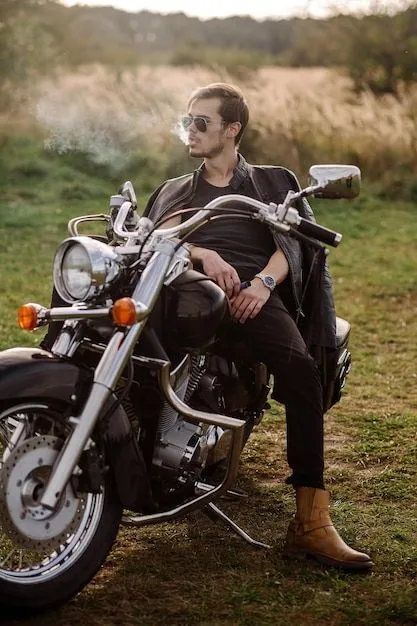 young-handsome-male-biker-is-sitting-smoking-motor-bike_210435-12747.webp